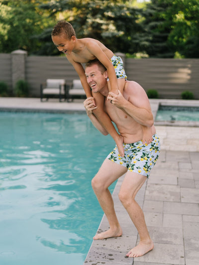 Father and Son Playing Poolside  wearing Navalora Amalfi Coast Lemon Matching Swimsuits 