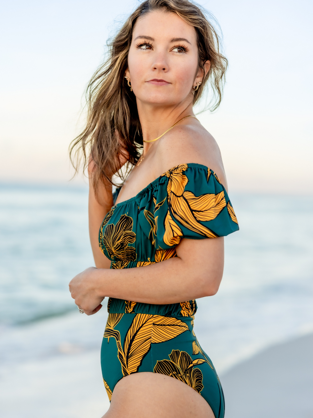 Women's Emerald Enchantment One Piece Swimsuit – women's swimwear, main image, Worn By Woman on the Beach, featuring a side view