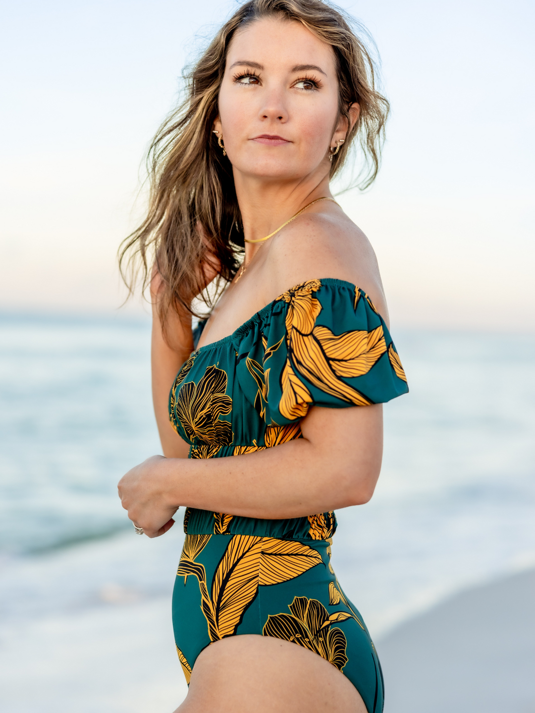 Women's Emerald Enchantment One Piece Swimsuit – women's swimwear, main image, Worn By Woman on the Beach, featuring a side view